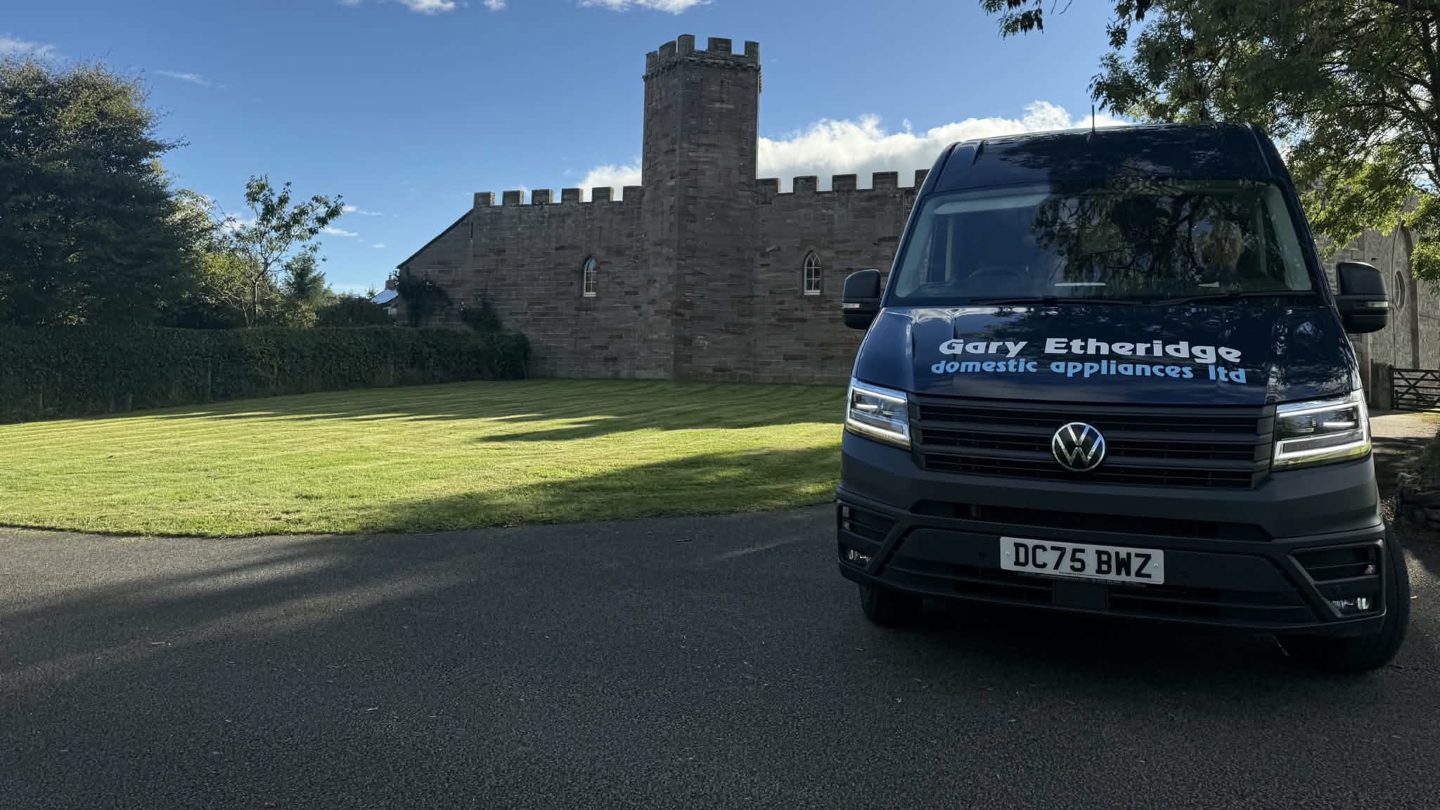 Our blue Gary Etheridge Volkswagen delivery van outside a stone building